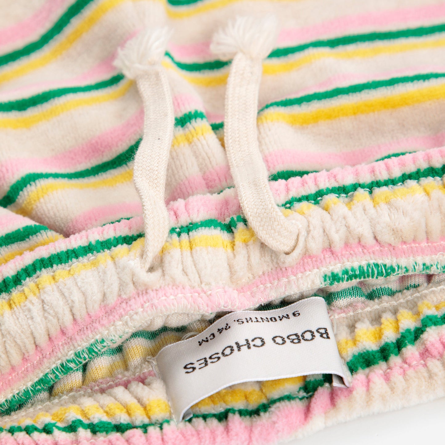 Close-up of a colorful striped fabric with a Bobo Choses label.