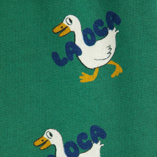 Two embroidered ducks with 'LA OCA' text on a green background
