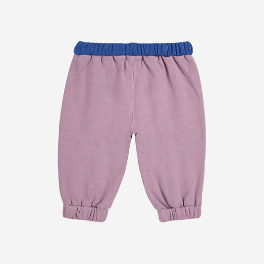 Pink baby pants with blue waistband on a white background