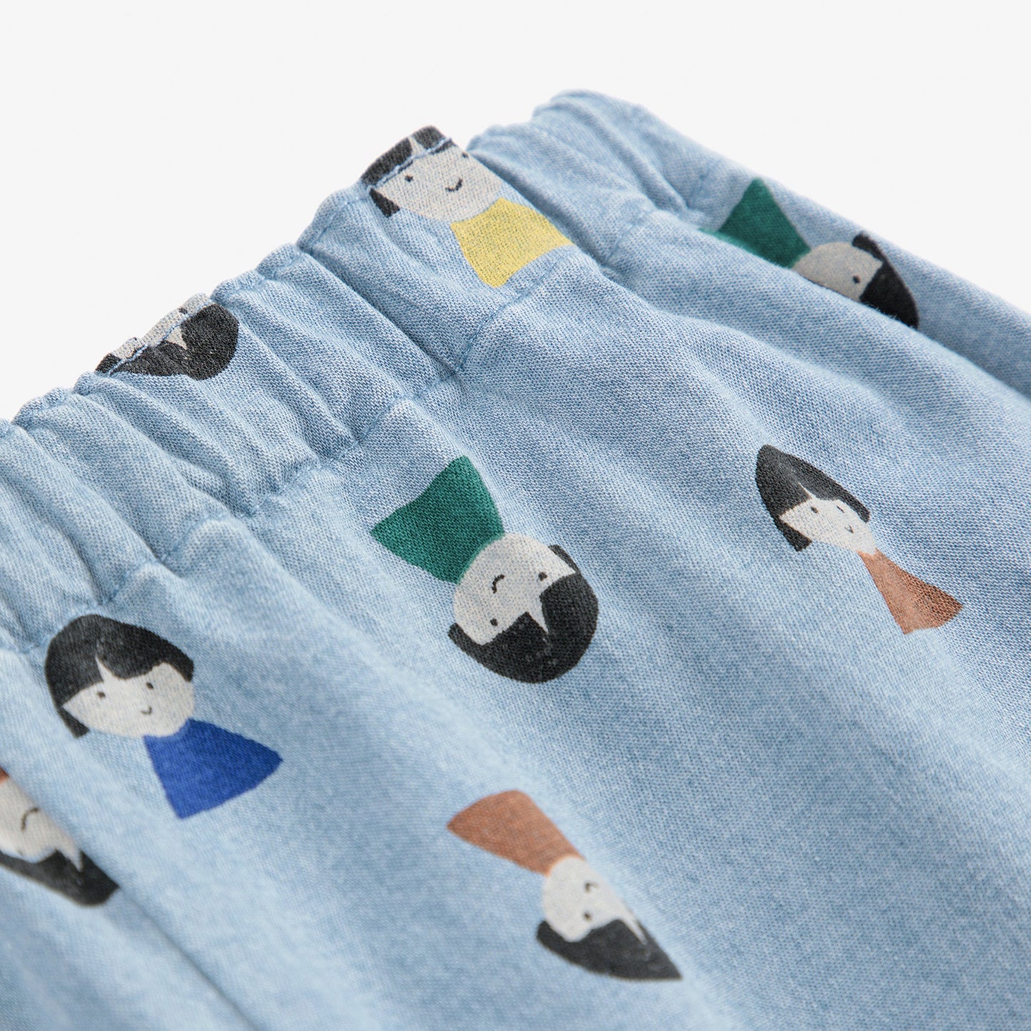 Blue fabric with cartoon character faces printed on it