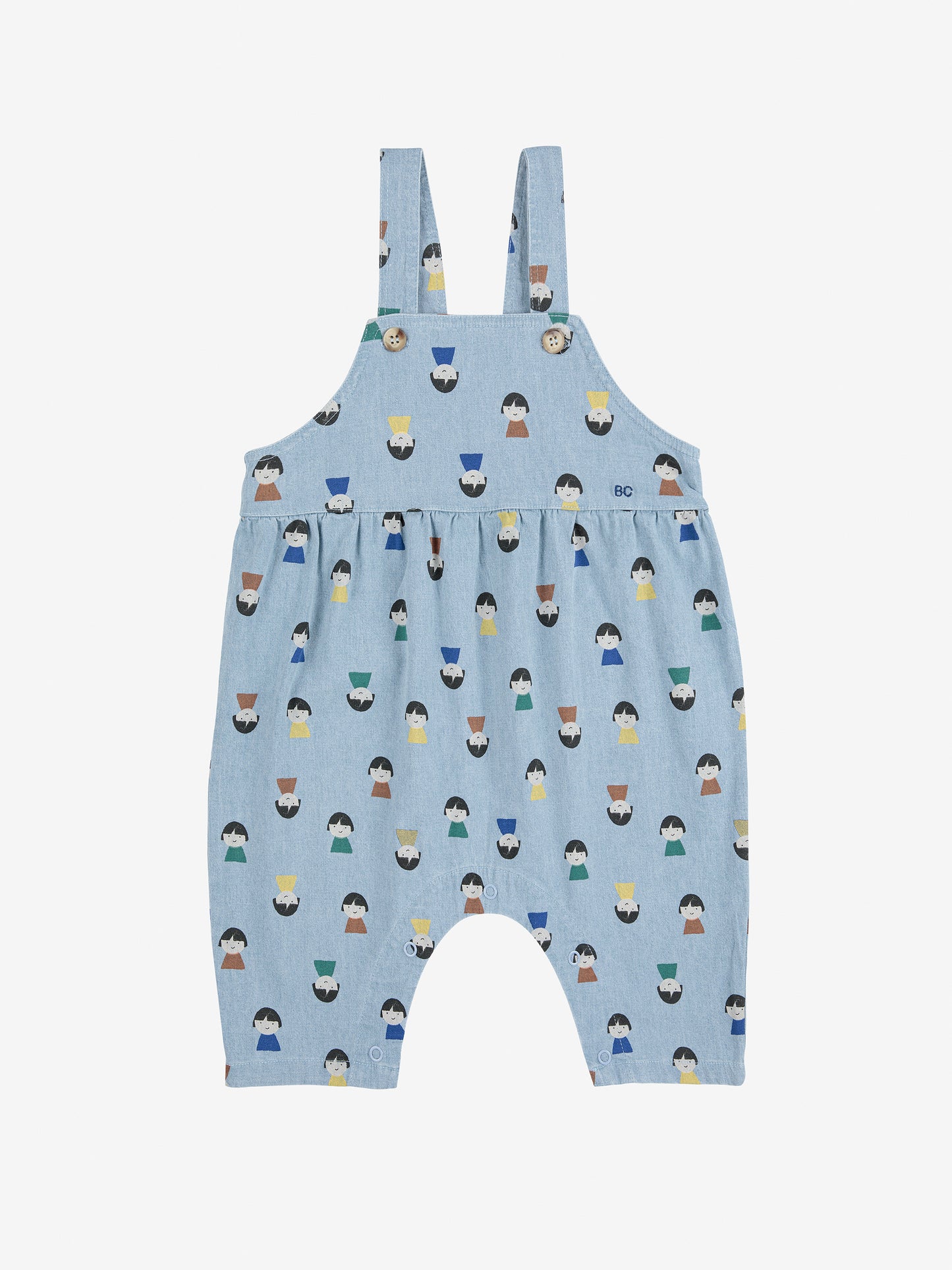 Blue children's overalls with a pattern of small figures on a white background