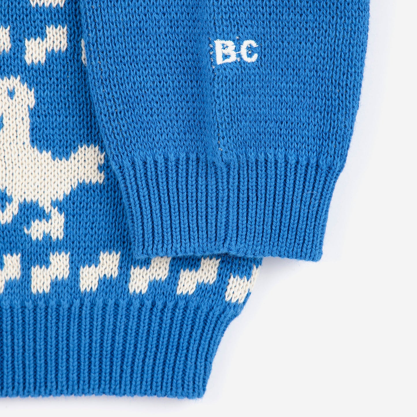 Blue knitted sweater with white pattern on a white background