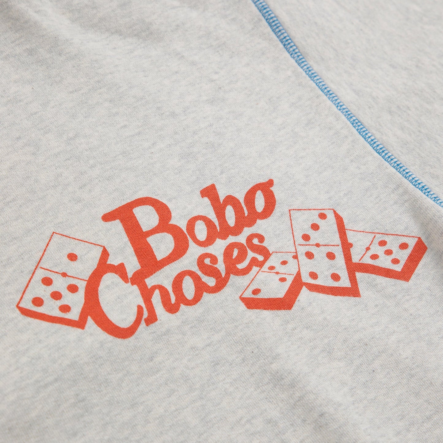 Gray sweatshirt with red 'Bobo Choses' text and dice graphics on a white background