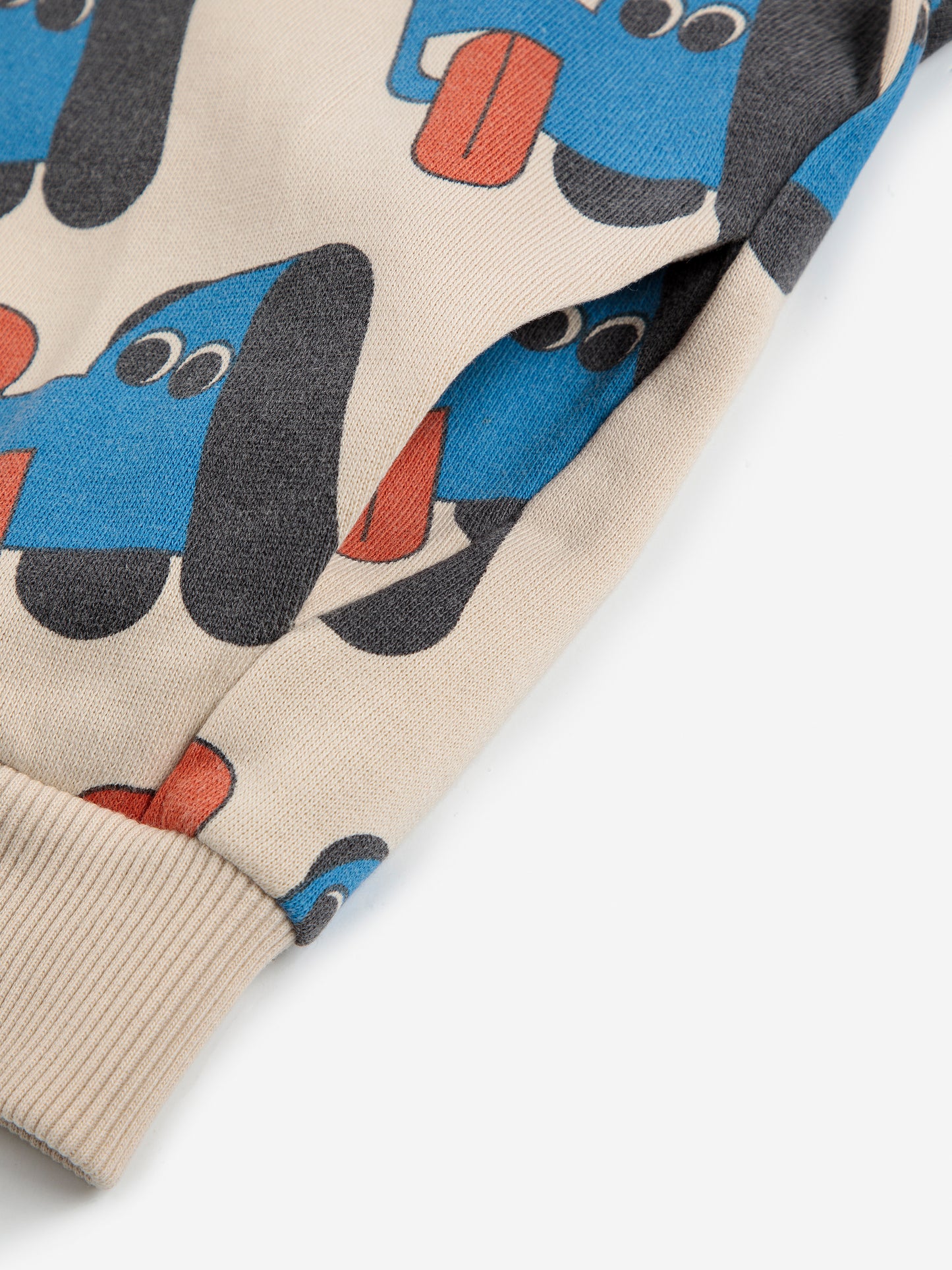 Close-up of a fabric with cartoon dog pattern on a beige background