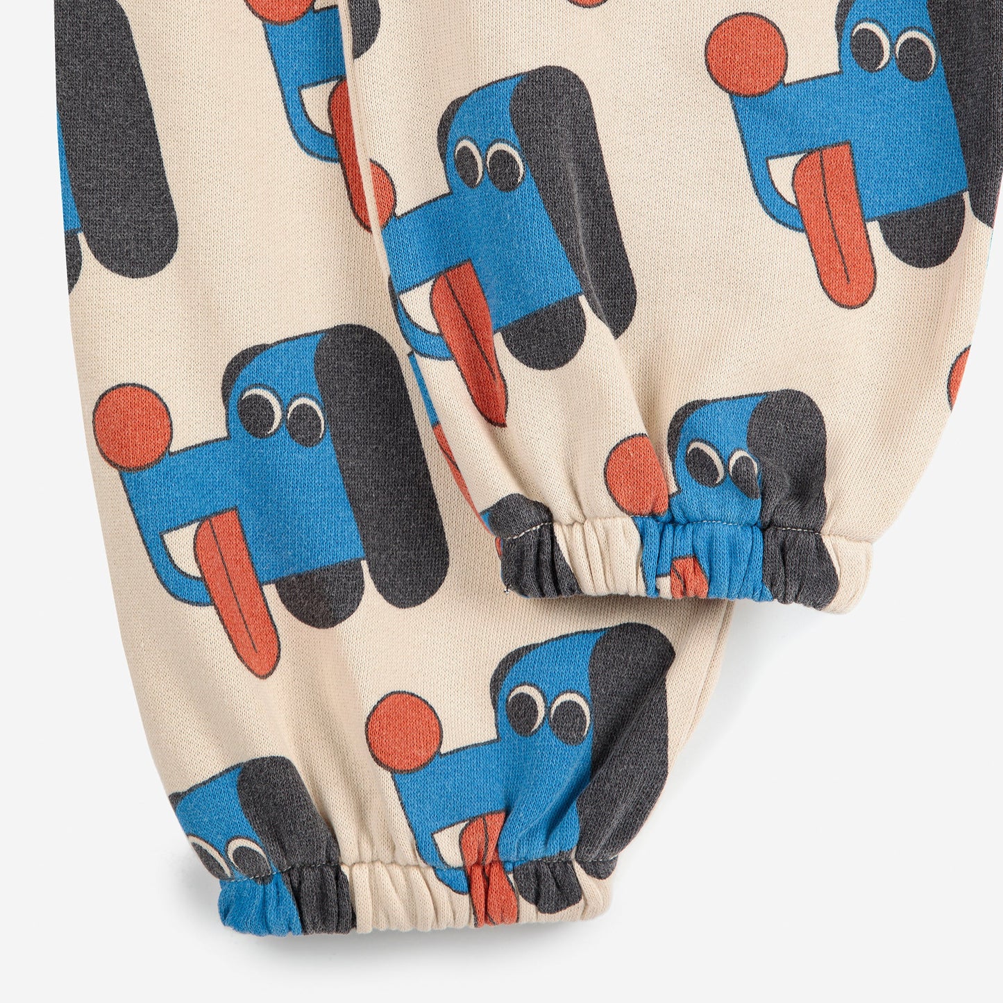 Children's pants with blue dog pattern on a beige background