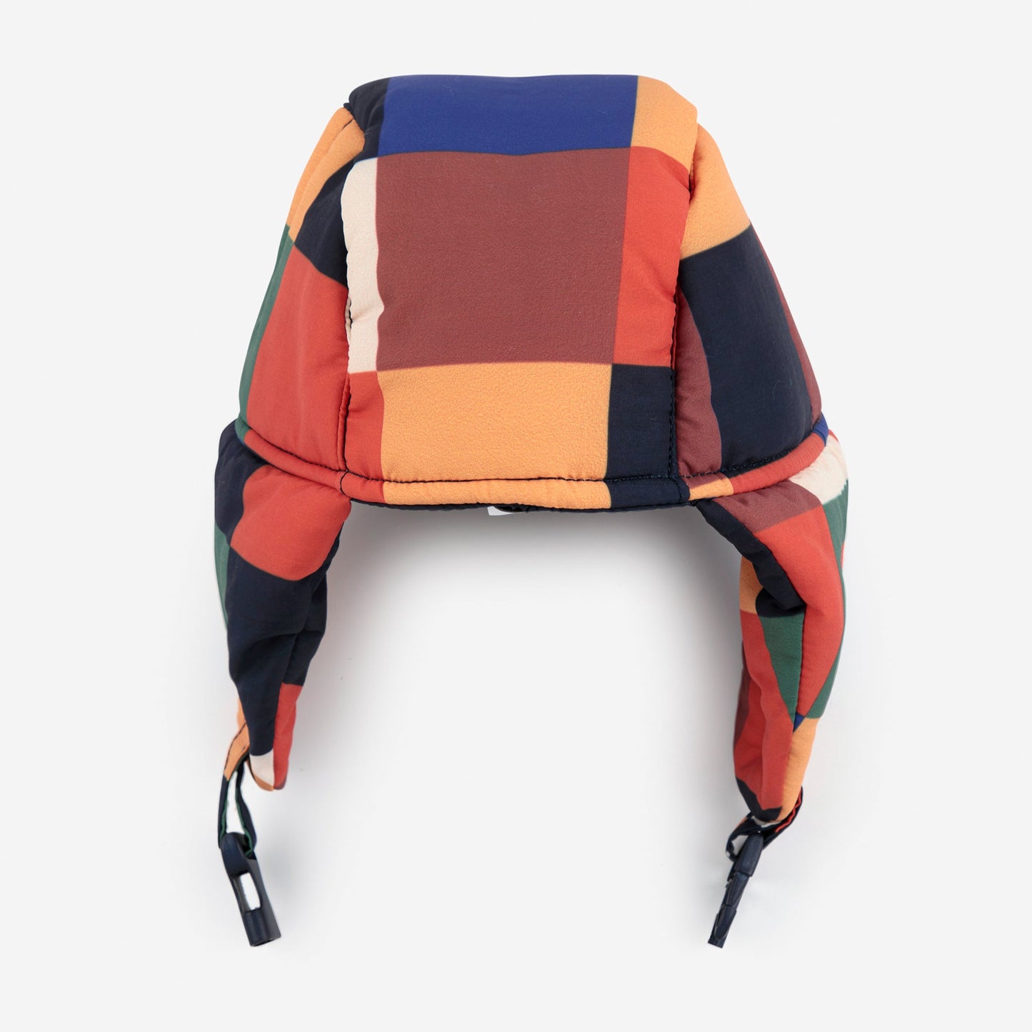 Colorful quilted helmet with a patchwork design on a white background