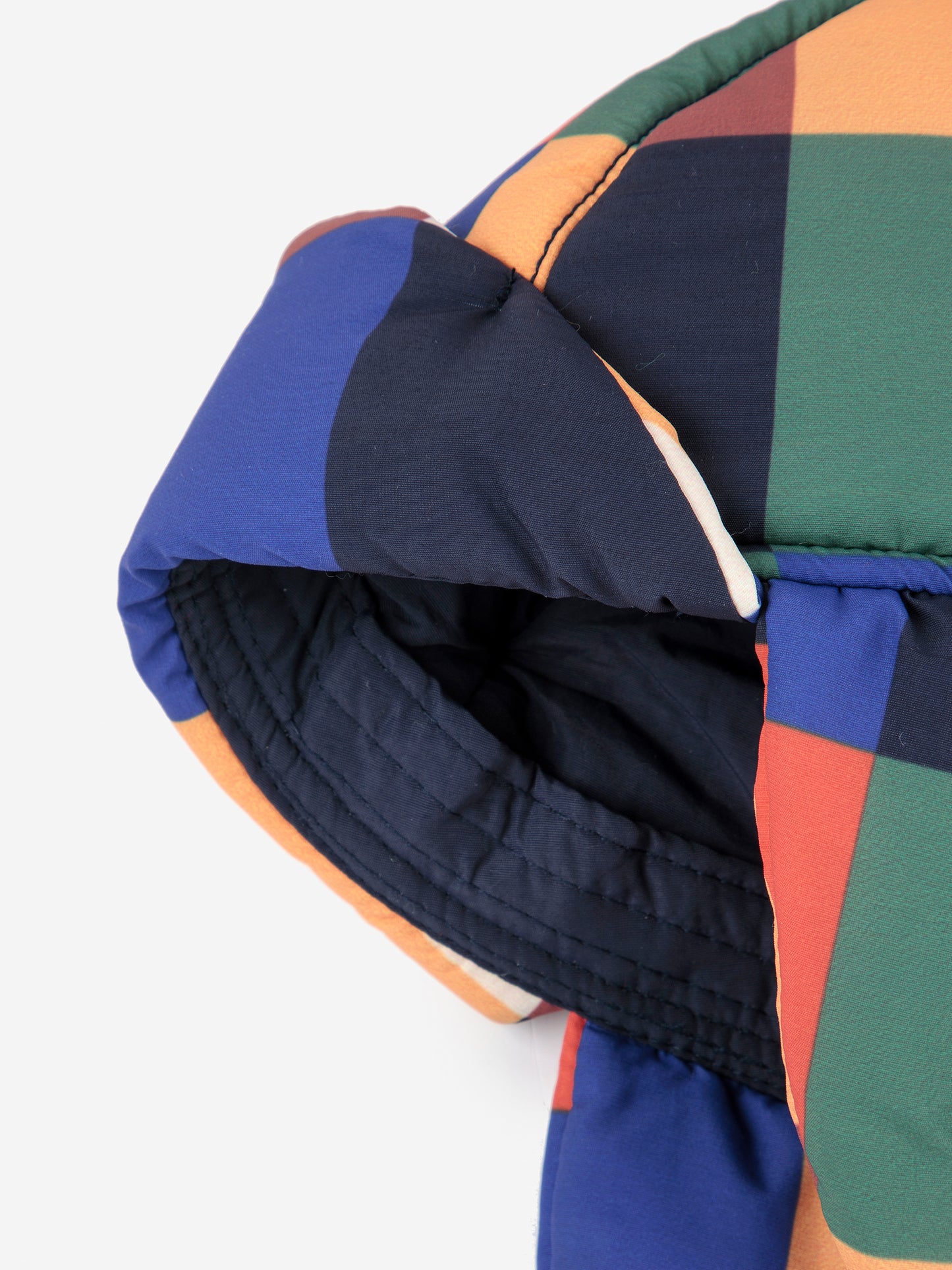 Colorful quilted jacket with geometric pattern on a white background