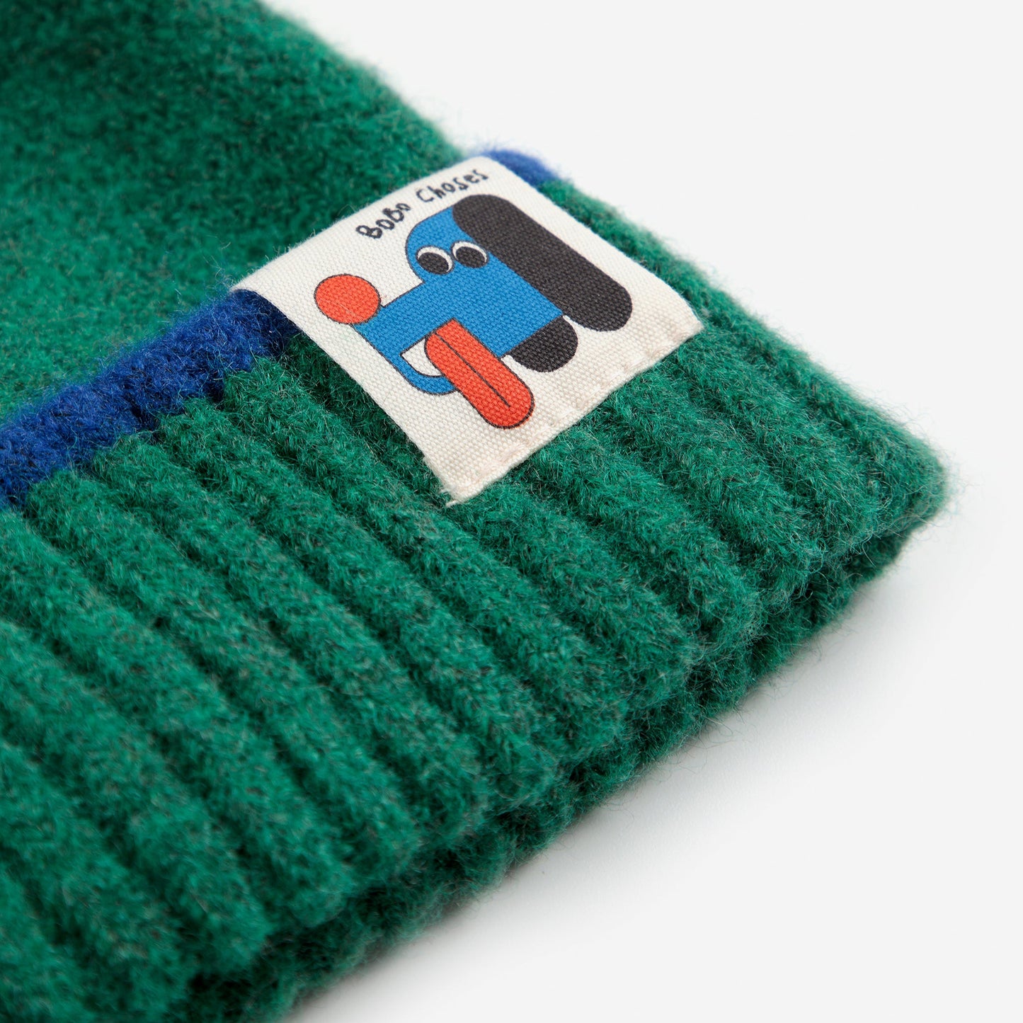 Green beanie with a cartoon label on a white background