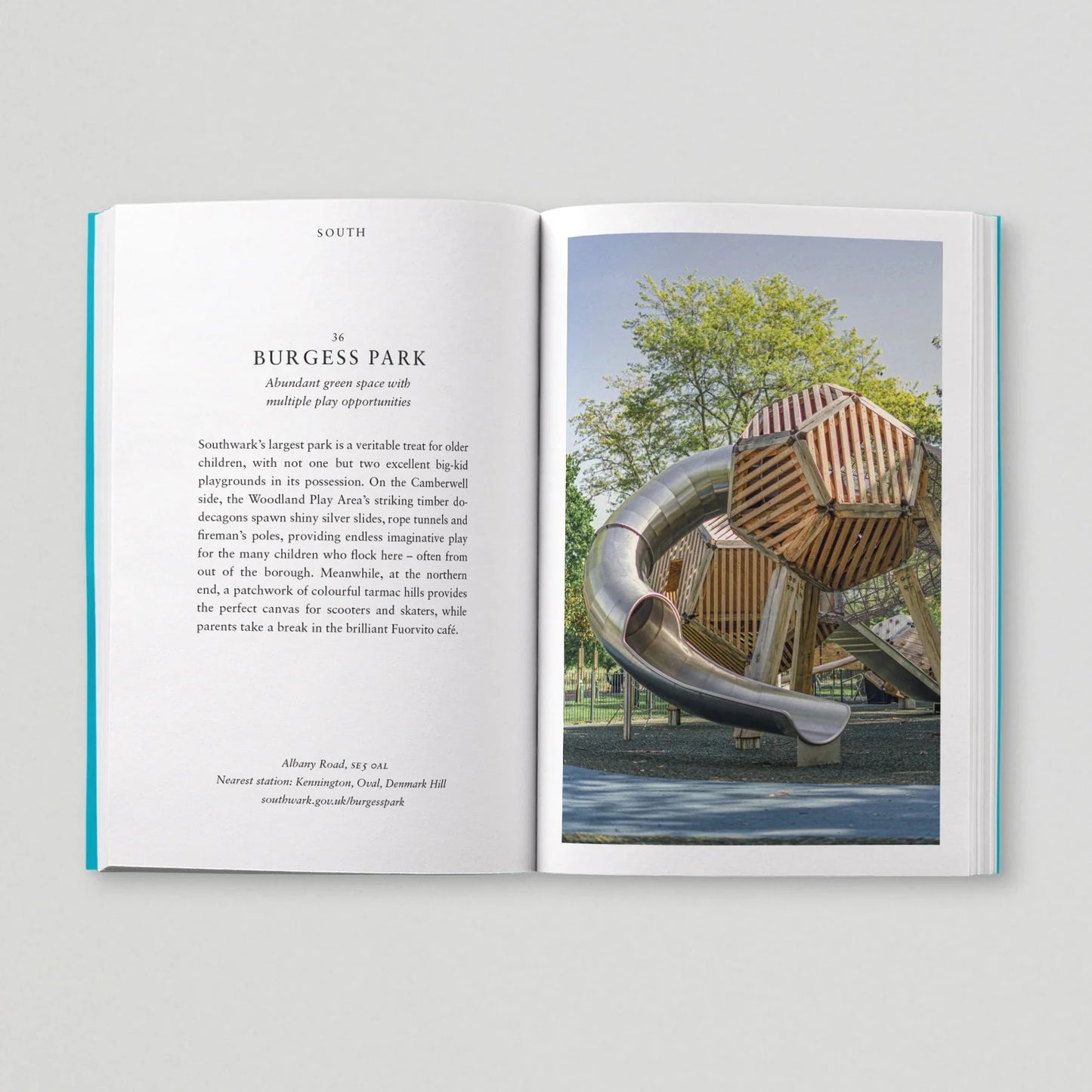 Open book showing text and a photograph of a modern playground structure.