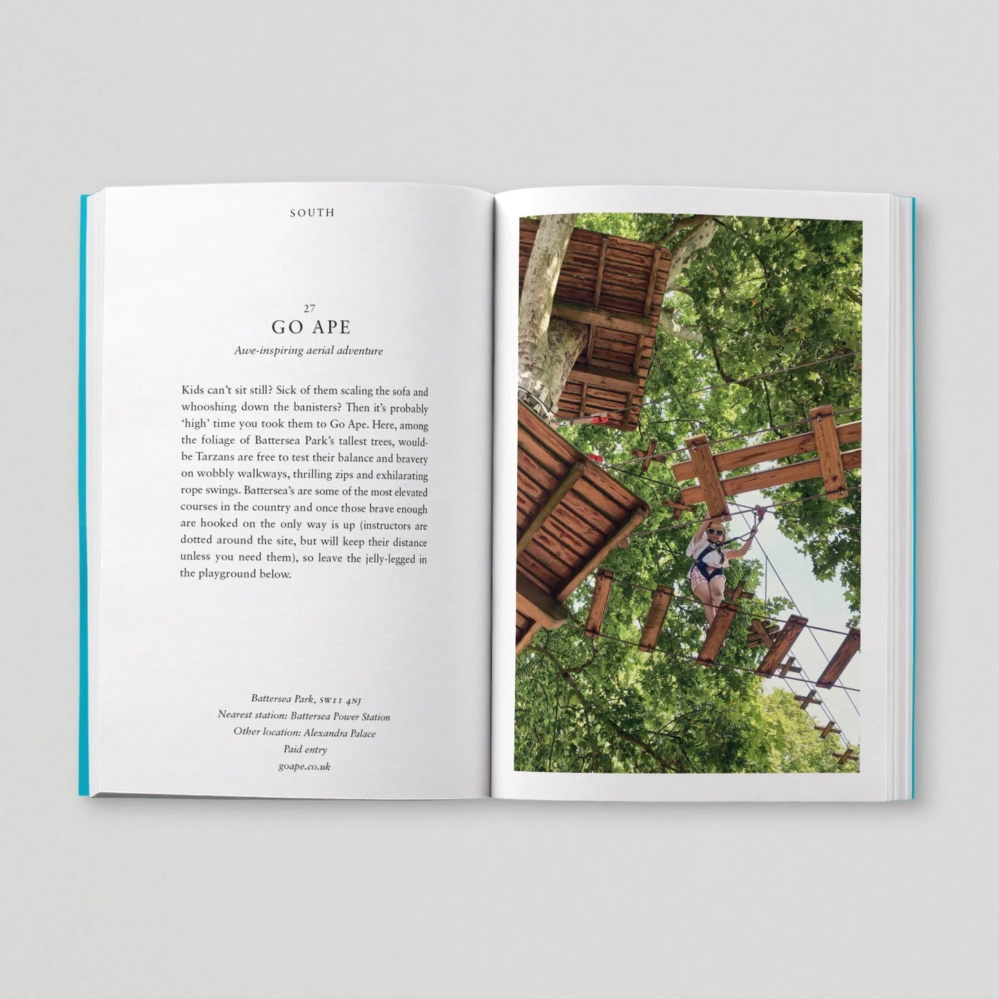Open book showing a page with text and an image of a person on a Go Ape adventure course.