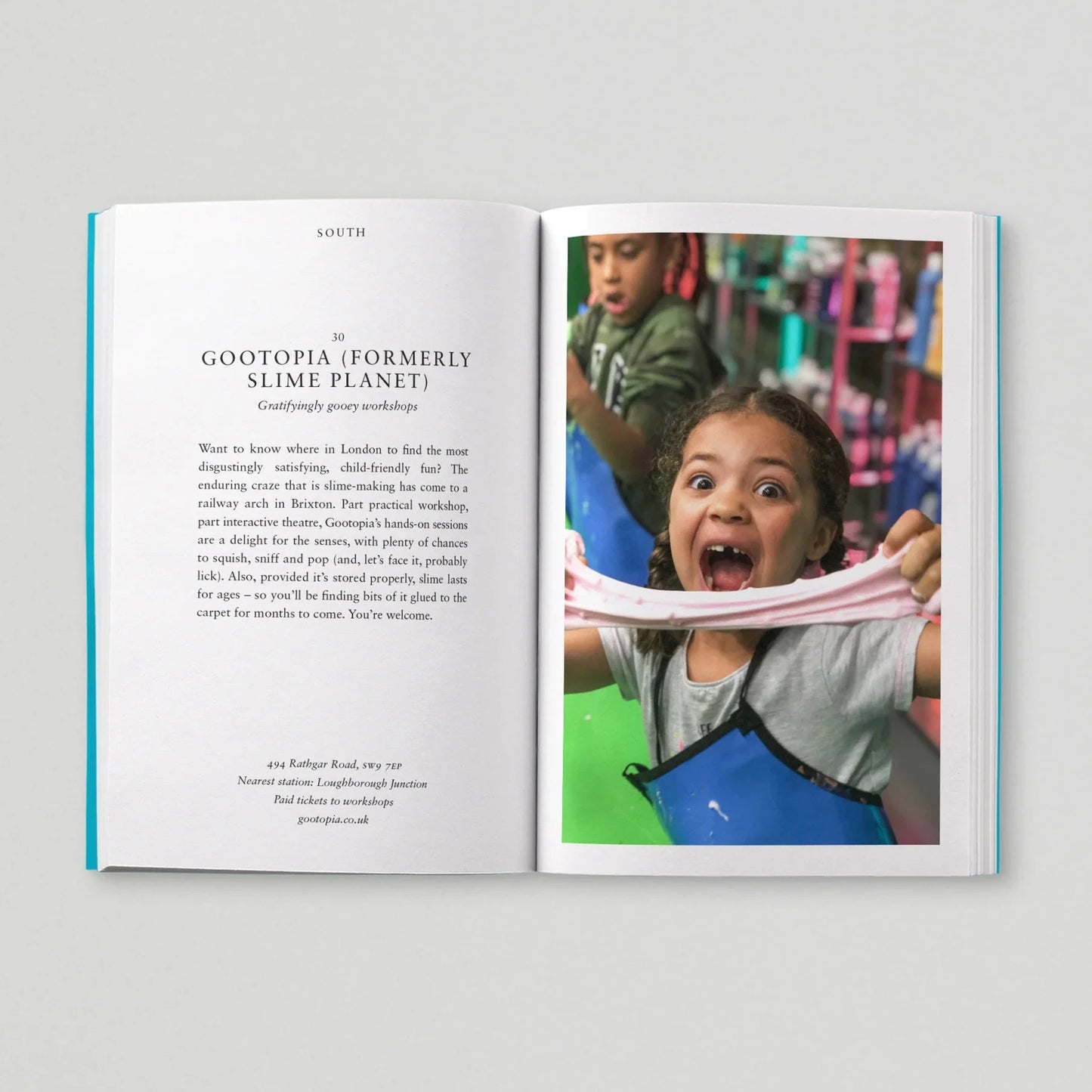 Open book with a page showing text and another with a child playing with pink slime.