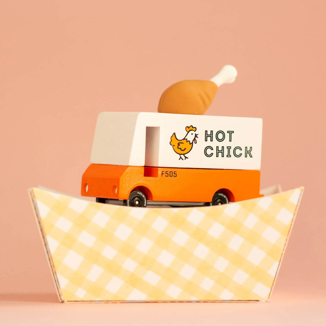 Toy truck with 'Hot Chick' branding on a pink background