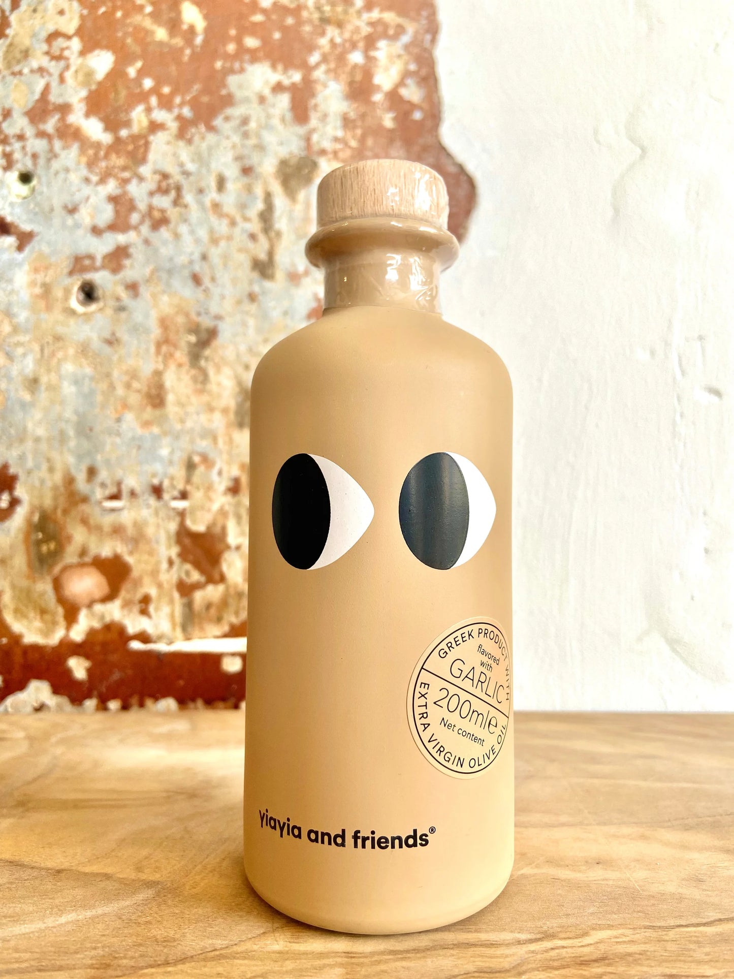 Beige bottle with eye design on a wooden surface