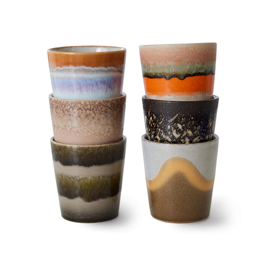 Two stacks of HKliving 70’s Ceramics Elements Coffee Mugs, each in a unique hand-glazed finish with earthy tones, textured patterns, and bold retro-inspired colour combinations, displayed against a white background.