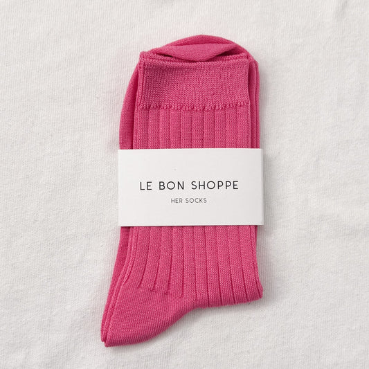 Pink socks with a white label on a light gray background