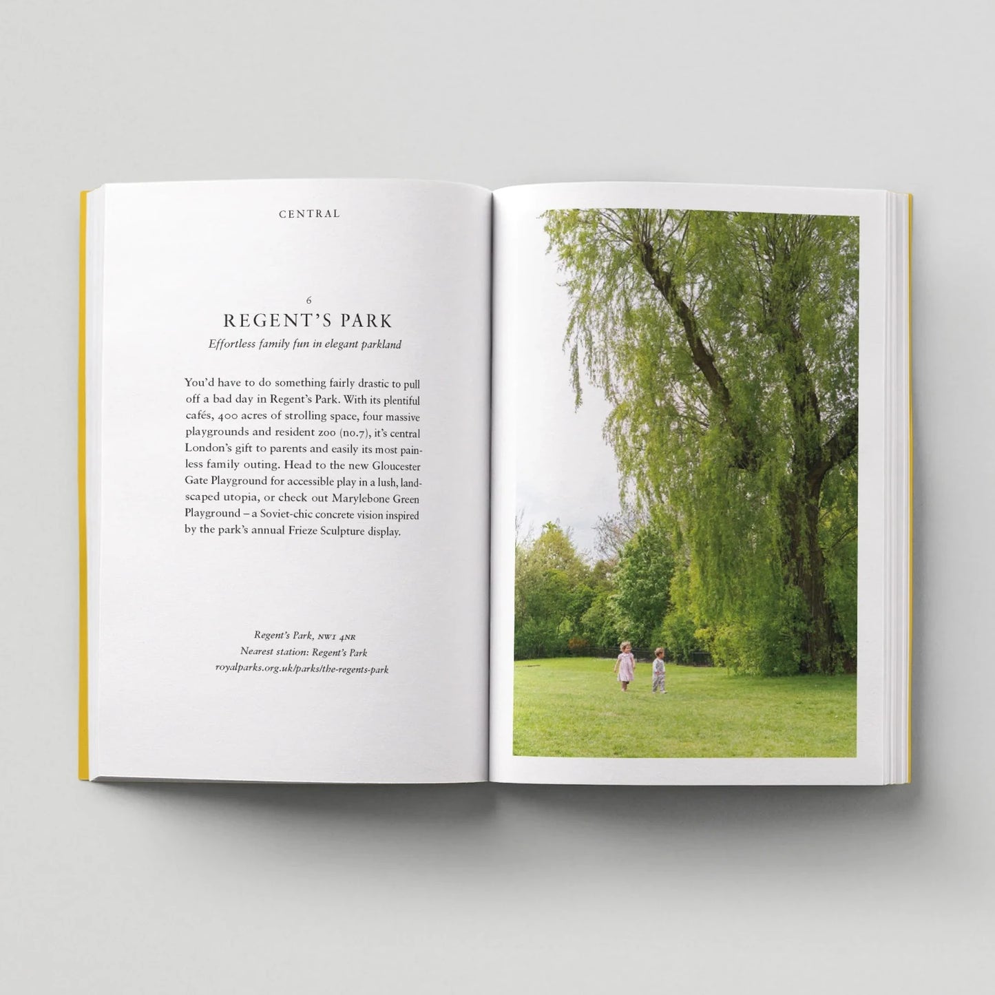 Open book showing text and a photograph of people in a park.