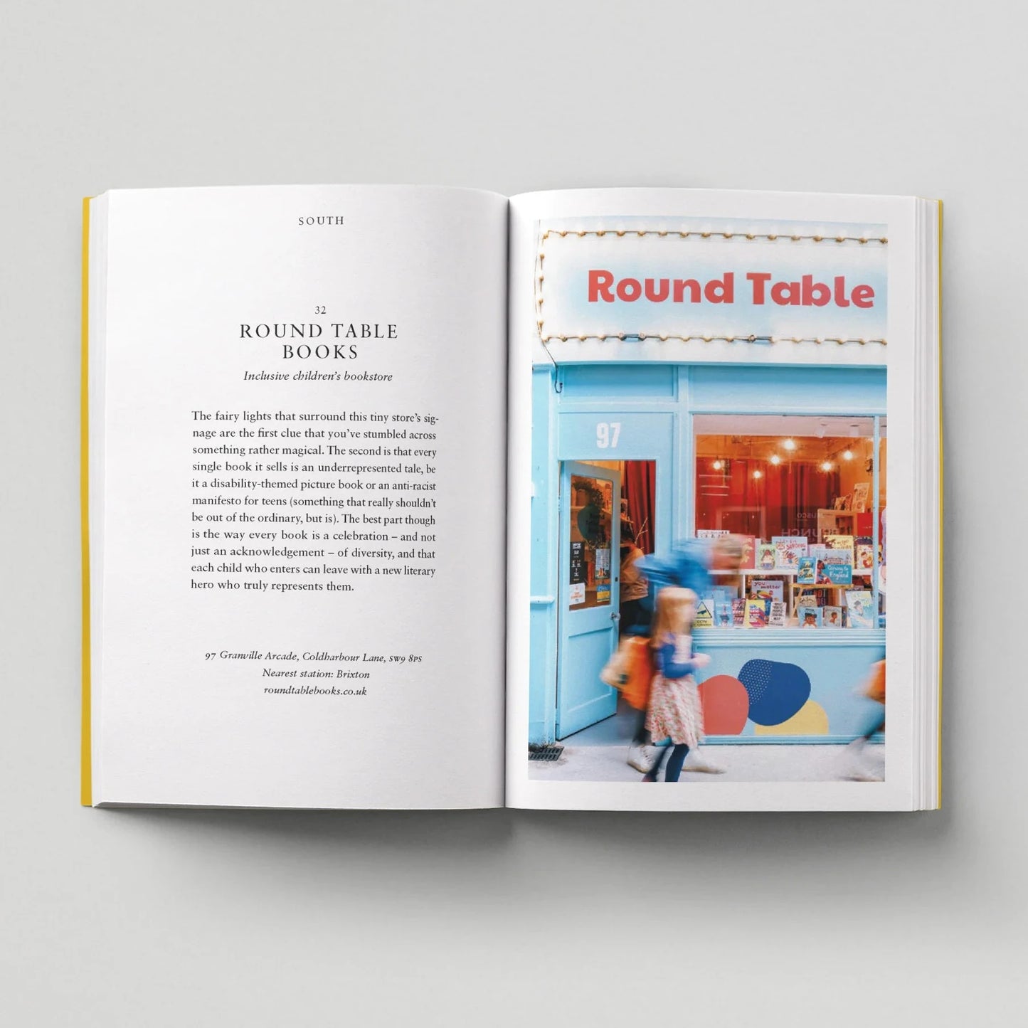 Open book showing a page with text and an image of a bookstore named 'Round Table'.
