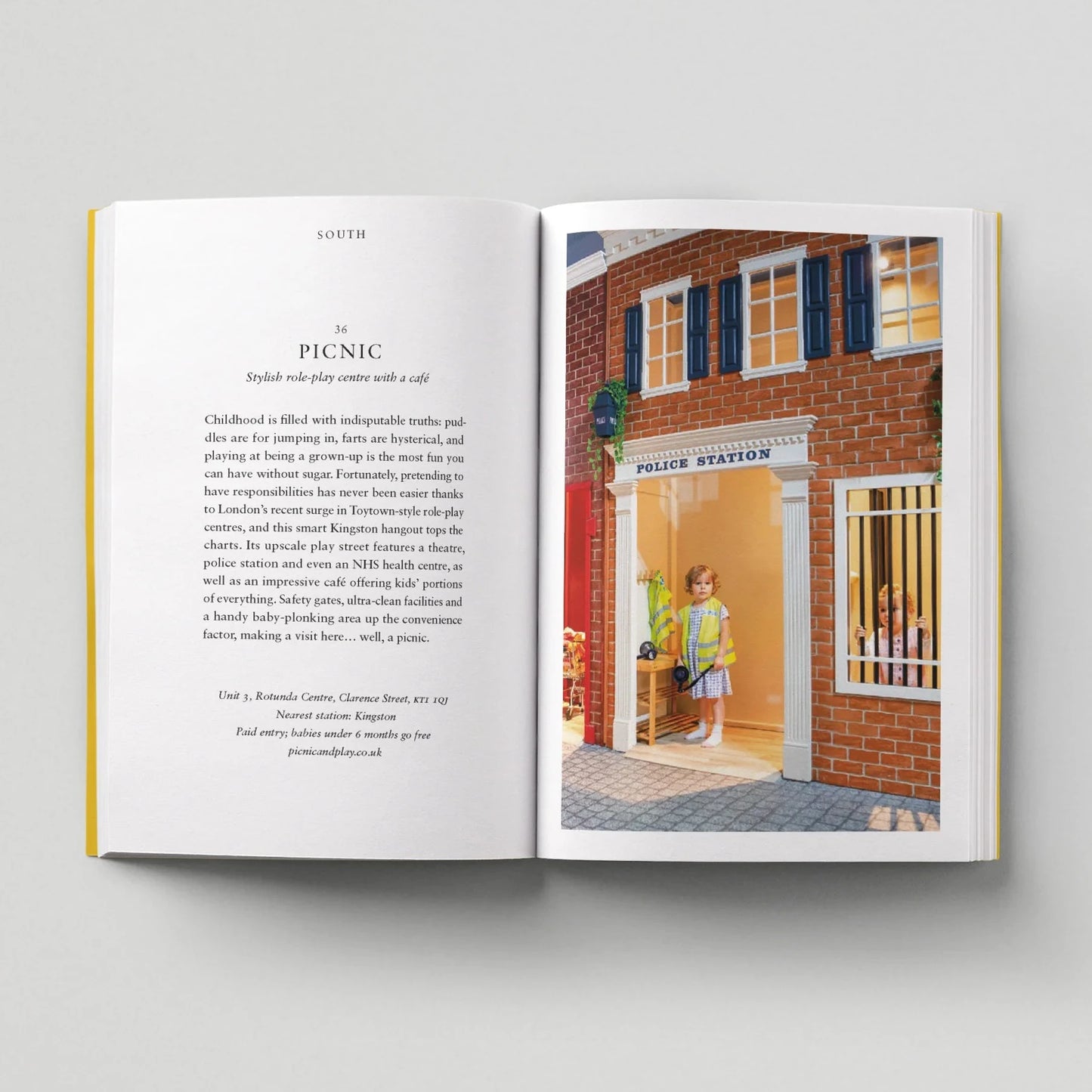 Open book showing a page with text and a color illustration of a police station.