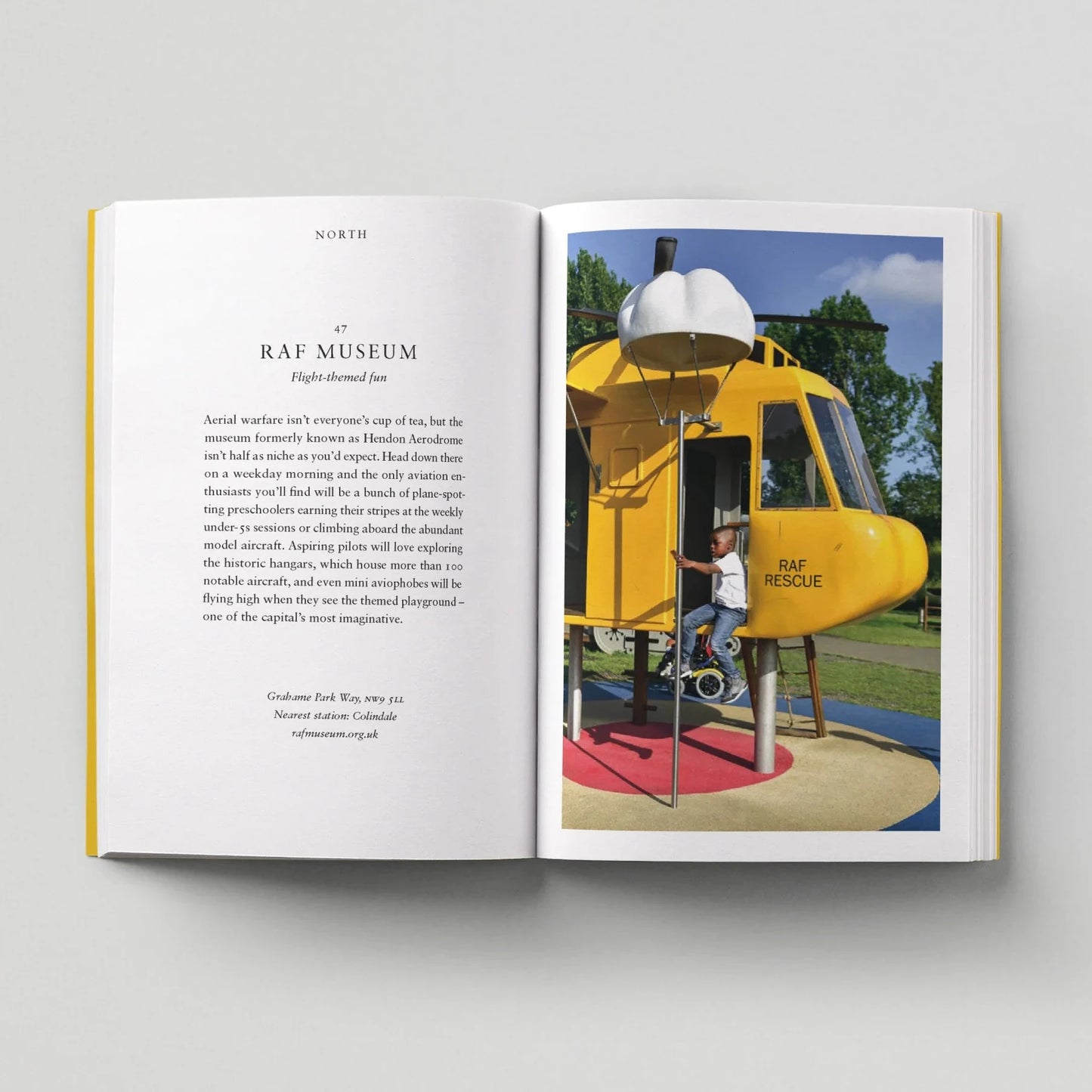 Open book showing a page with text and an image of a yellow helicopter at RAF Museum.