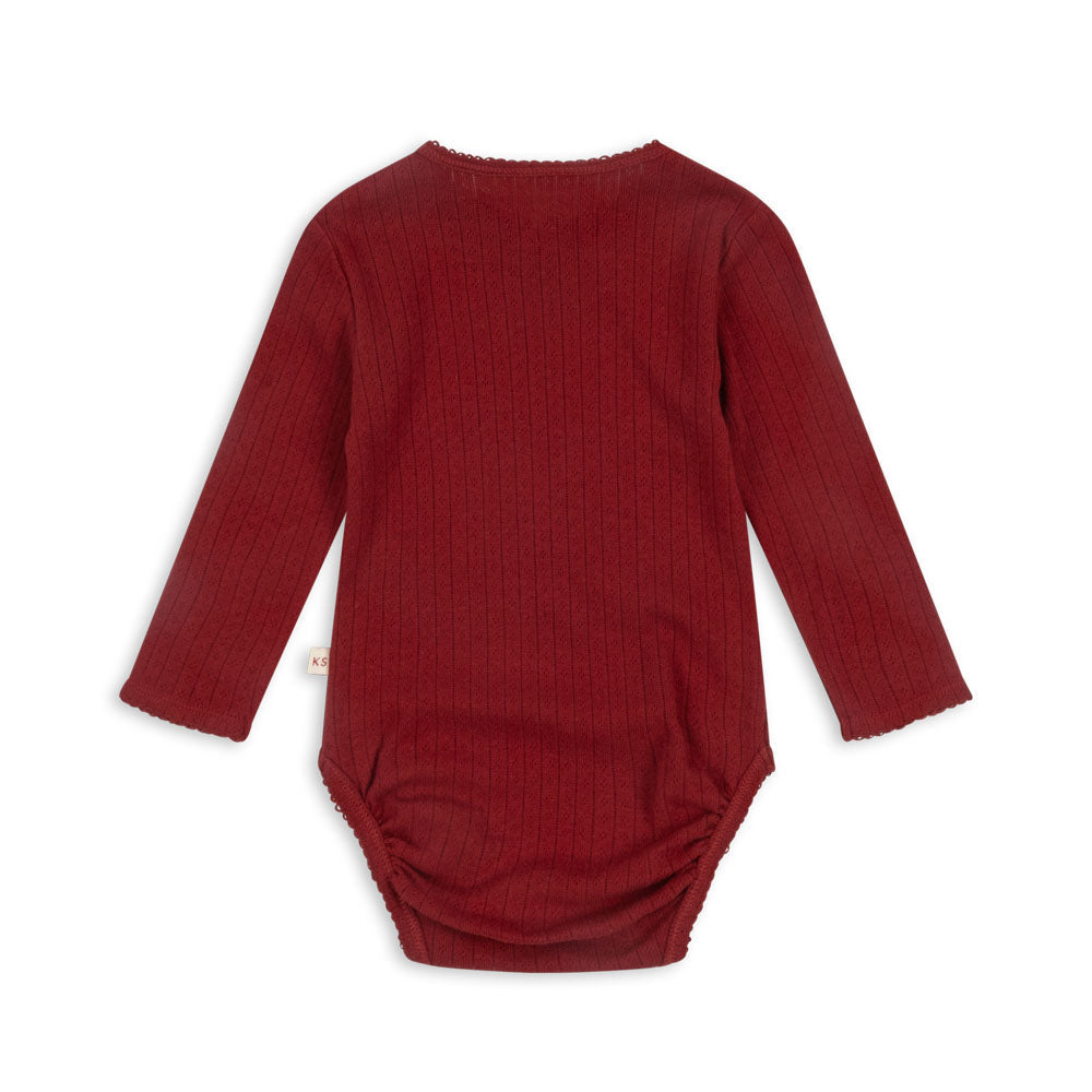 Back view of the Konges Sløjd Red Dahlia Newborn Minnie Body, highlighting the soft ribbed fabric and long sleeves for extra warmth.