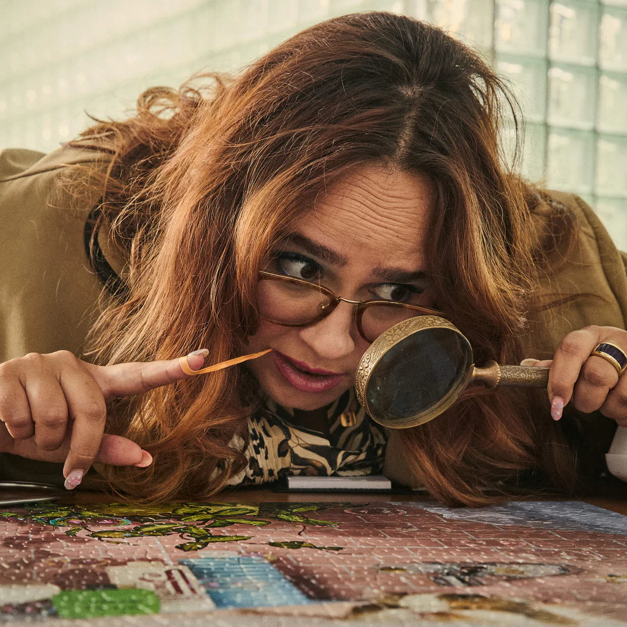 Woman with magnifying glass and spyglass examining a puzzle