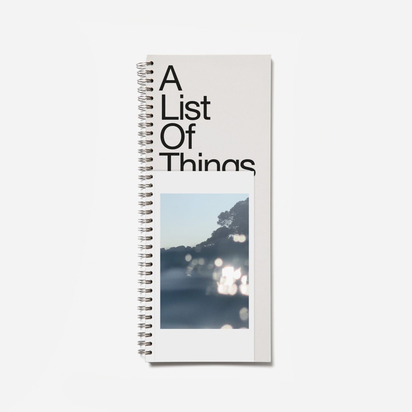 Notebook titled 'A List Of Things' with a scenic cover on a white background