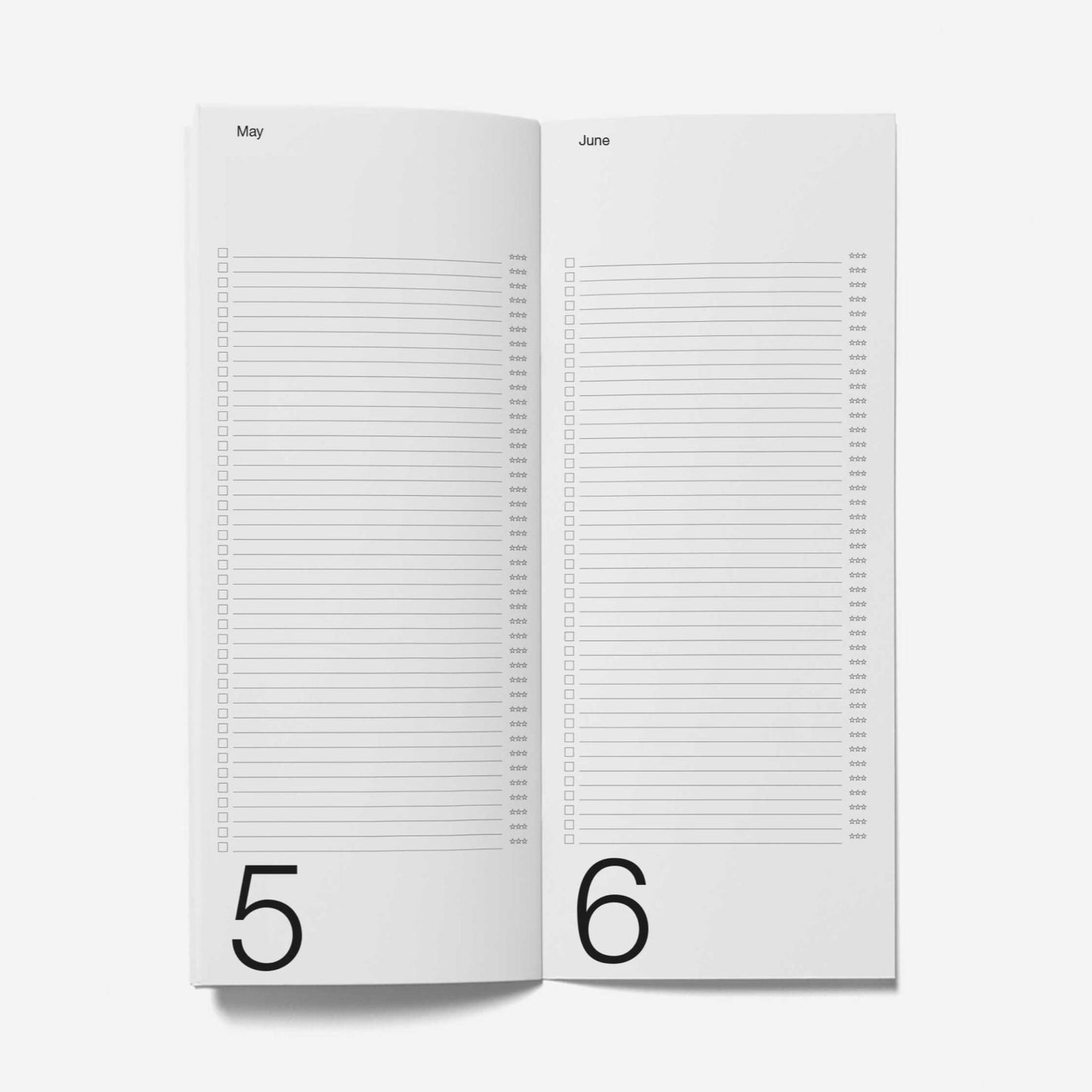 Open notebook with pages numbered 5 and 6 on a white background
