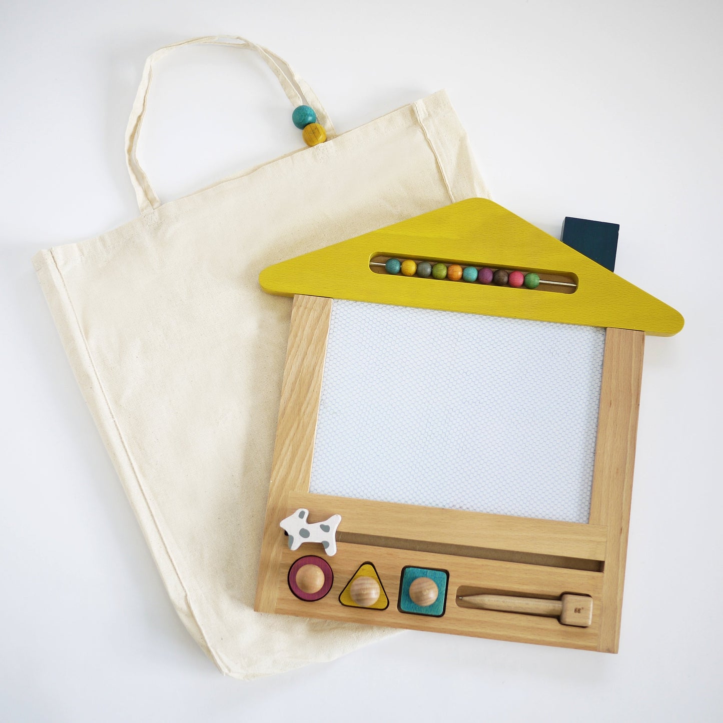 Wooden toy with colourful shapes and a yellow roof on a white background