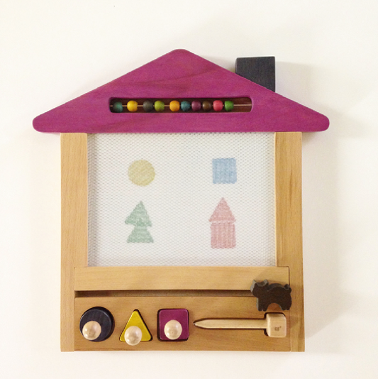 Children's toy with coloruful shapes and a magnetic board on a white background