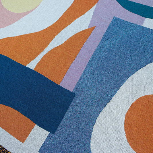 A close-up of the Essien Throw, highlighting its intricate woven details, rich colour contrasts, and soft recycled cotton fabric.