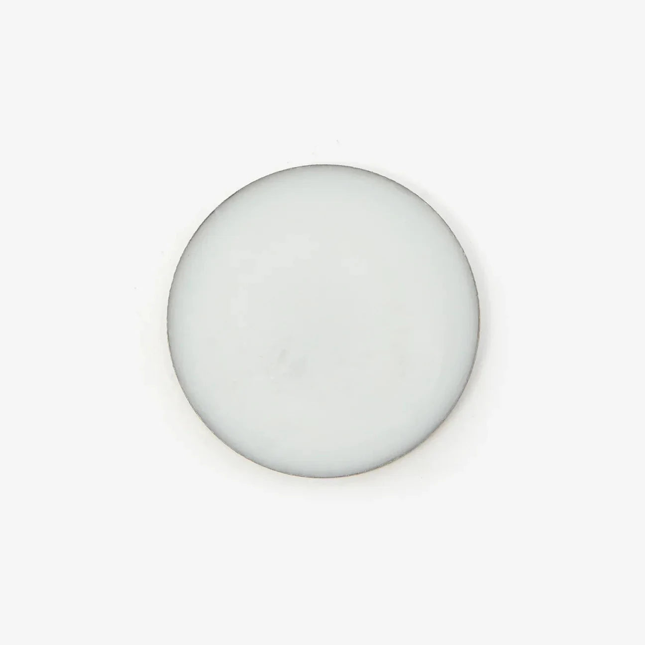 An overhead shot of the circular pot of solid perfume balm against a white background.
