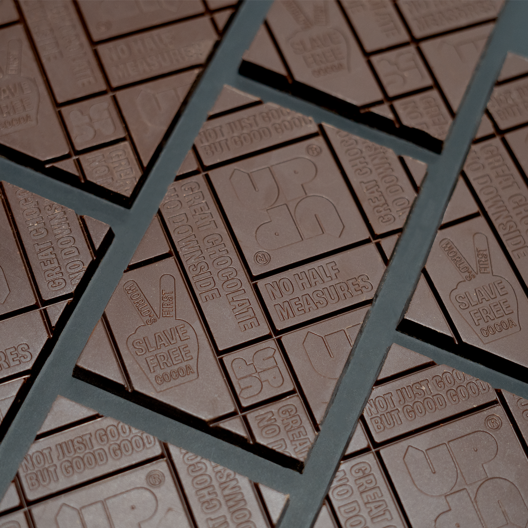Close-up of chocolate bars with branding and text, overlaid by a geometric pattern.
