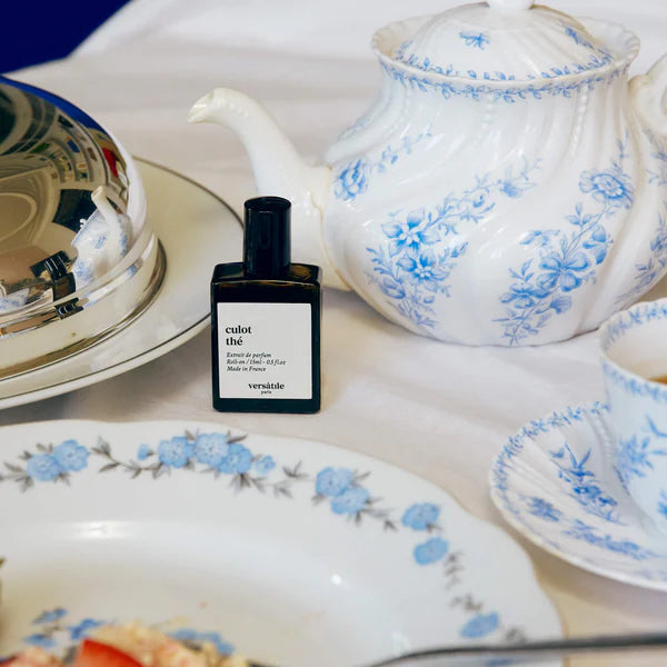 Versace colot thee perfume bottle on a floral teacup and saucer set