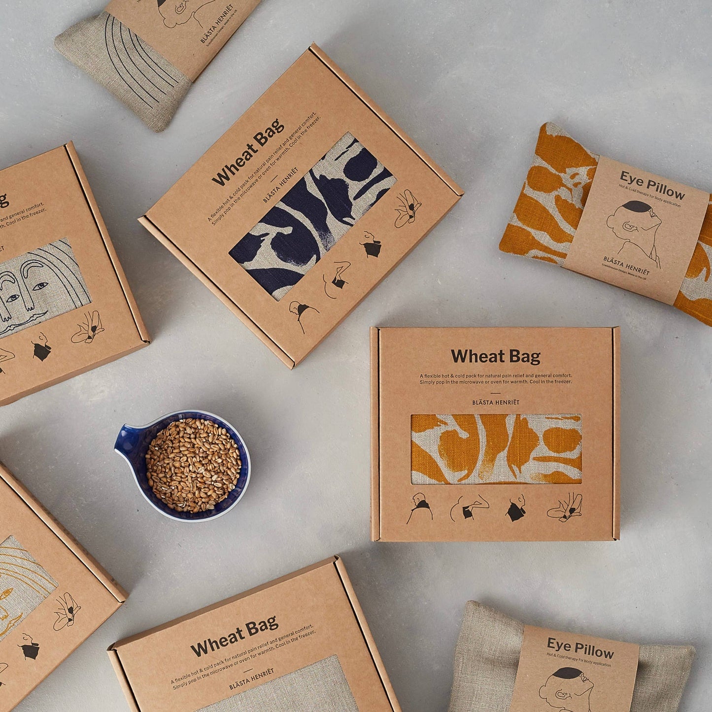 Wheat bags and packaging on a light gray surface