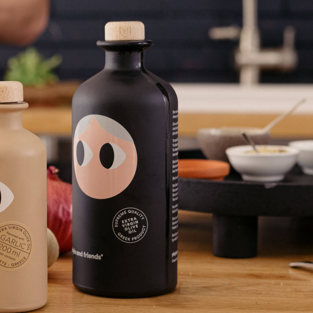 Black bottle with a face design on a wooden surface