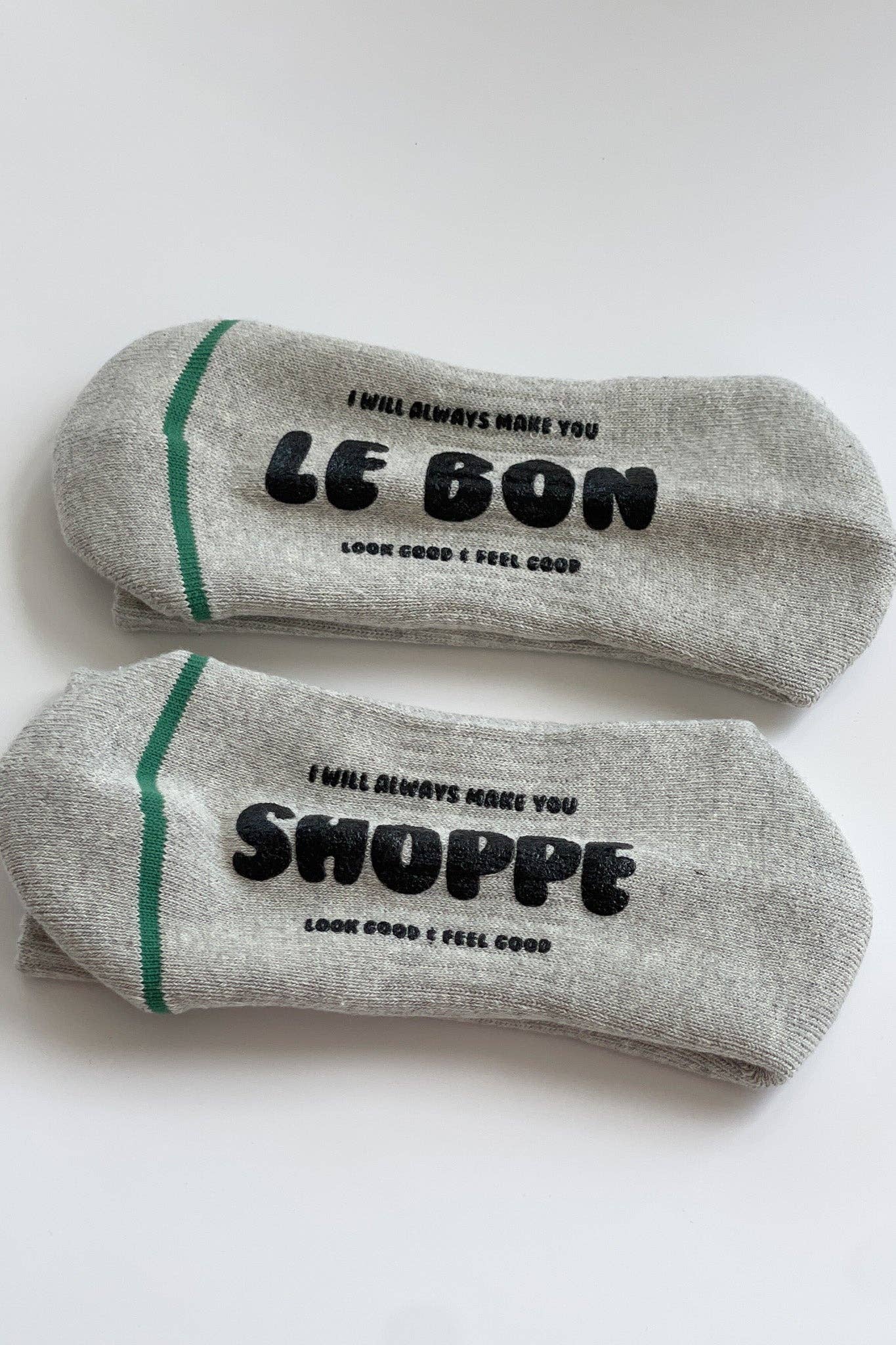 Two gray socks with text on a white background
