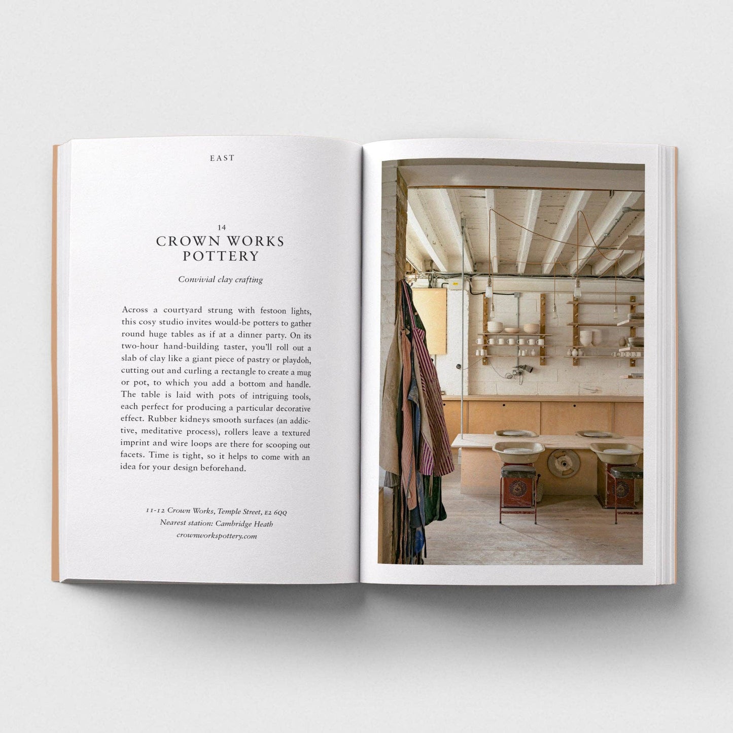 Open book showing a photograph of a pottery studio on the right page with text on the left.