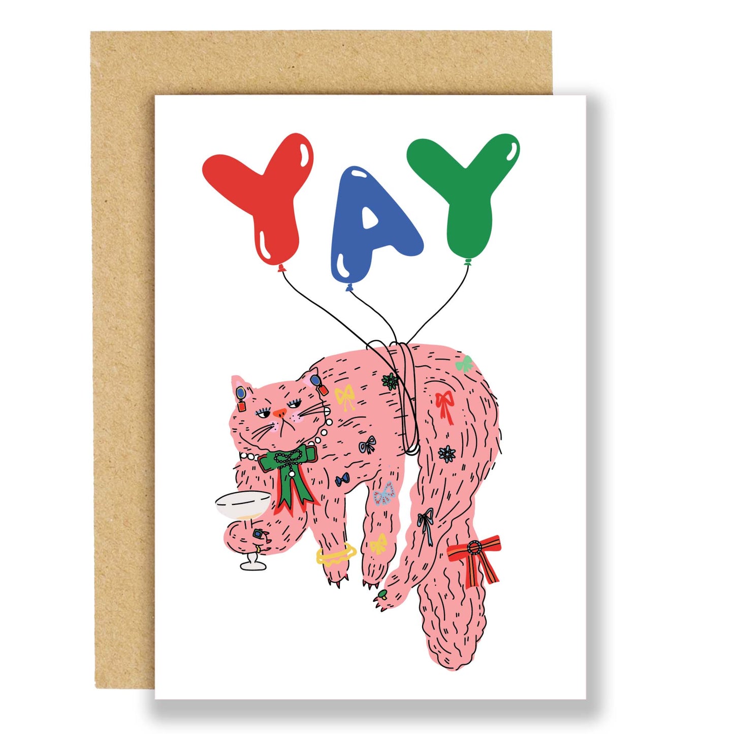 A greeting card with an illustration of a cat with balloons and party accessories, holding a sign with the word 'YAY'. The card is accompanied by a brown Kraft envelope.