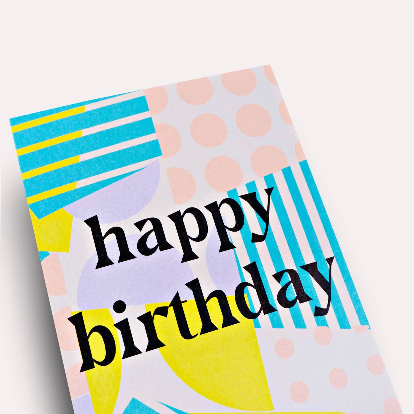 Colorful birthday card with geometric patterns and 'happy birthday' text on a white background