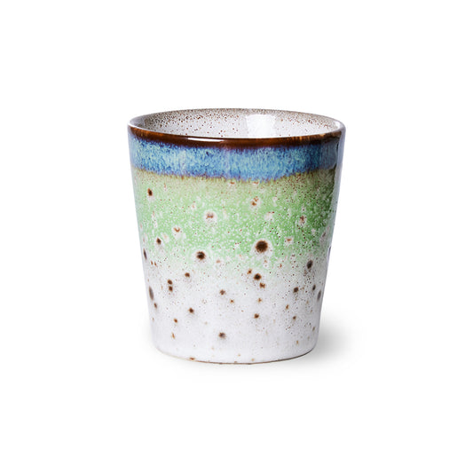 Ceramic mug with speckled design on a white background