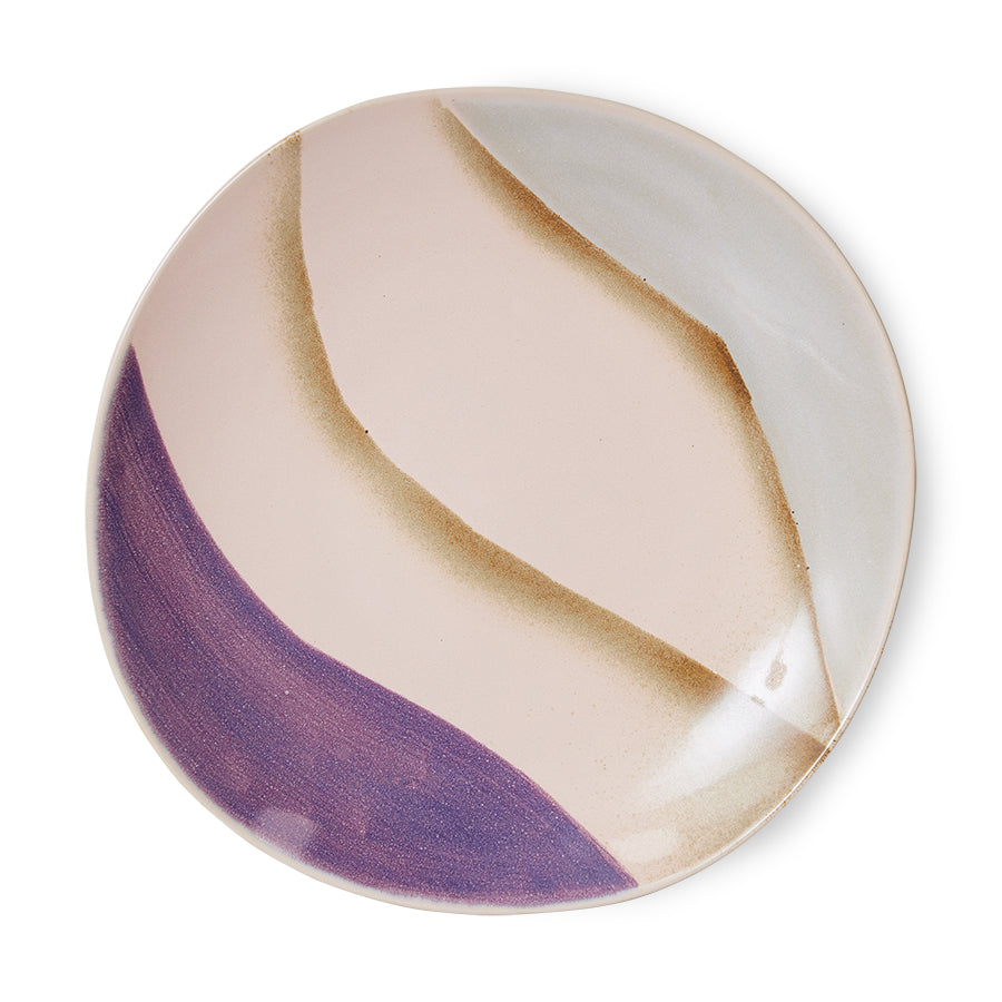 Round ceramic plate with purple and beige design on a white background