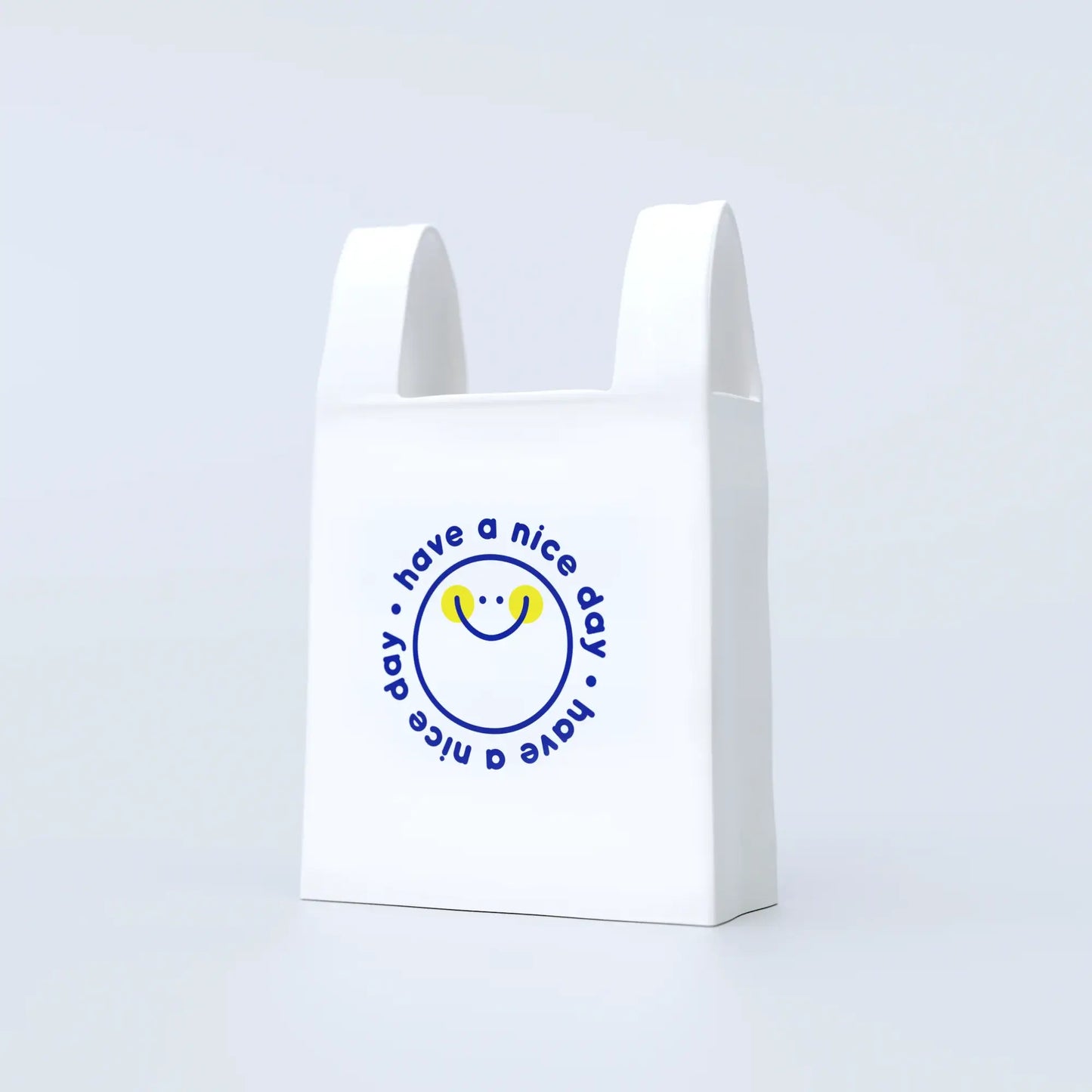 A white ceramic vase designed to resemble a plastic bag with a blue circular logo and text saying 'have a nice day' on the front.