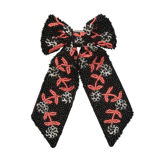 Black bow-shaped beaded hair accessory with red and silver floral patterns on a white background