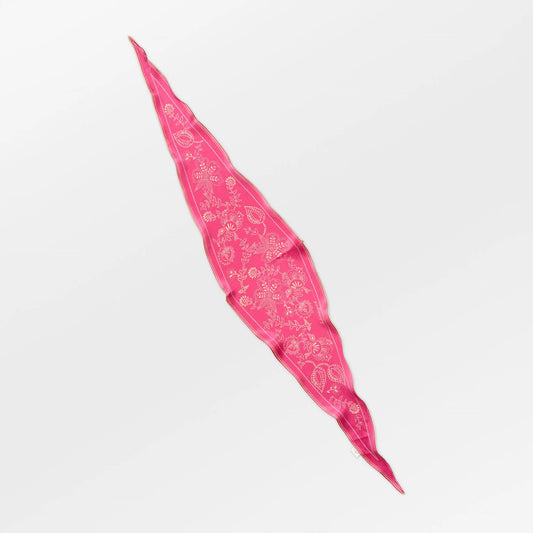 Pink bandana with white patterns on a light gray background