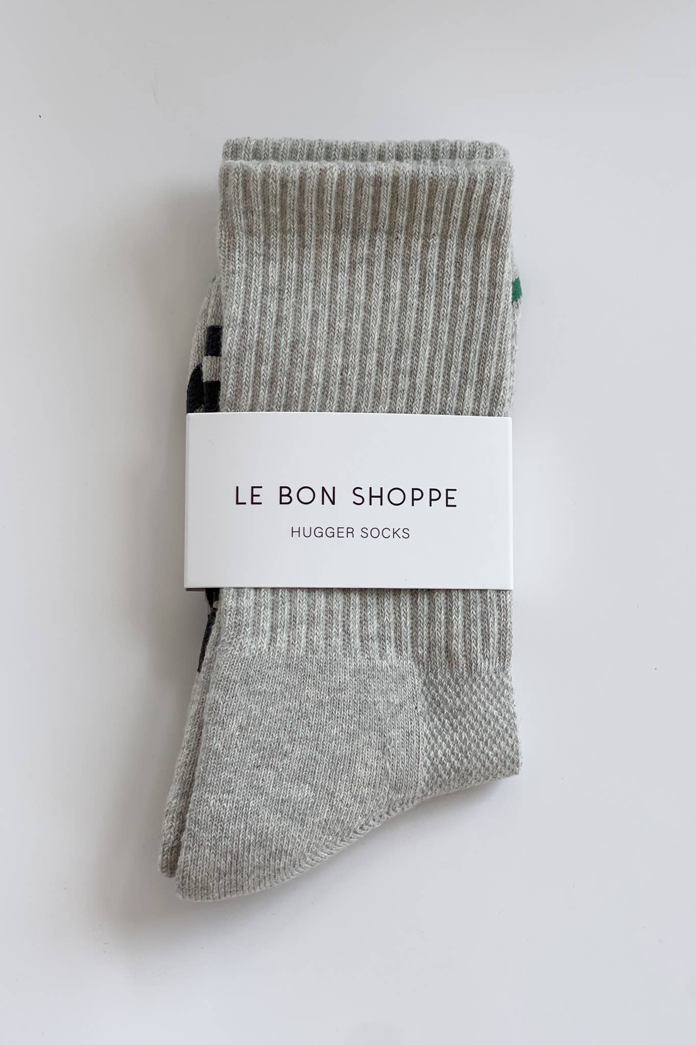 Pair of gray socks with a 'Le Bon Shoppe' label on a white background