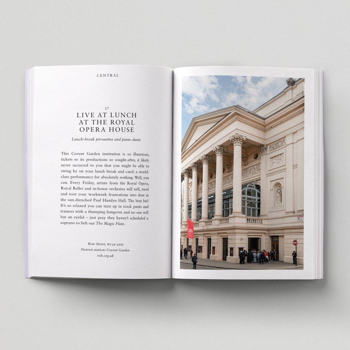 Open book with text and a photograph of the Royal Opera House on a light gray background