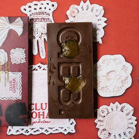 Casa Bosques chocolate bar with decorative packaging on a red background