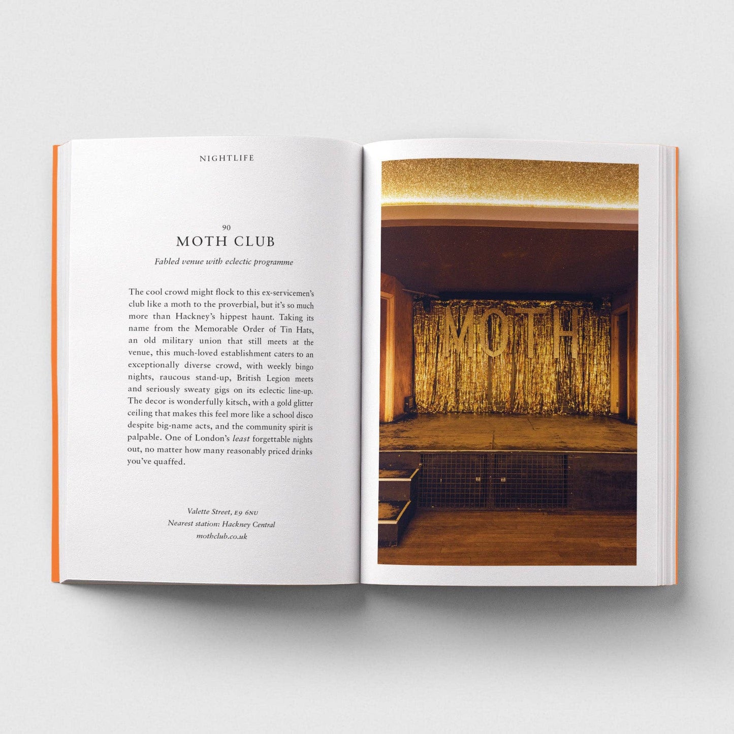 Open book with text on one page and a photograph of a room with 'MOTH' on the wall on the other page.