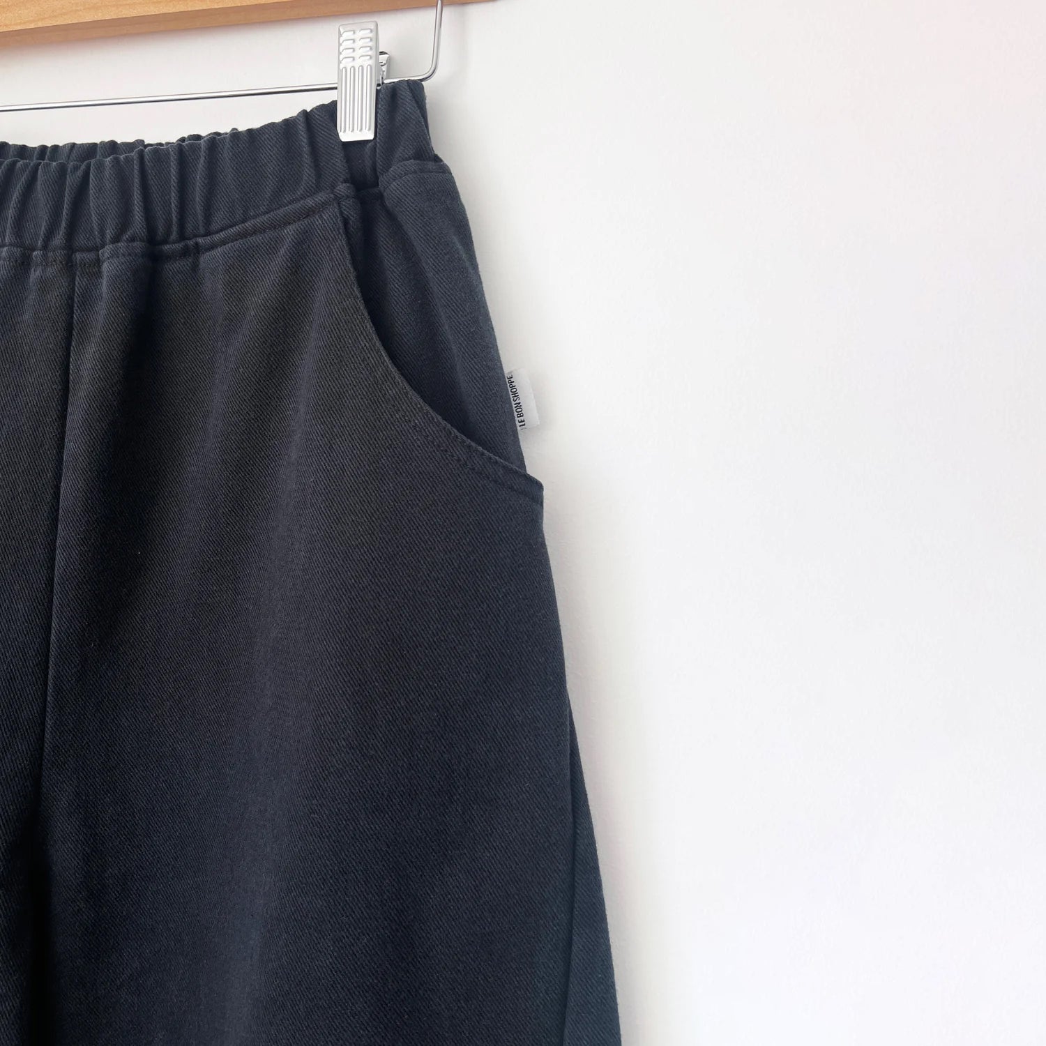 denim black ballon pants with a curved seam on both sides of the leg, with a chunky Rouches elasticated waist band, and two pockets on the side
