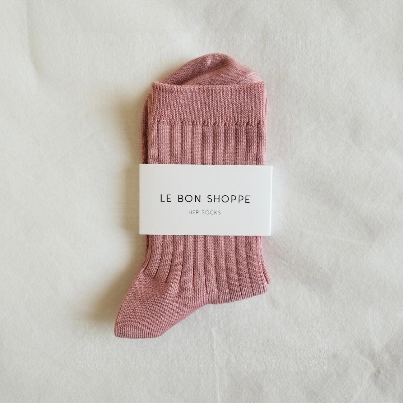A pair of pink, ribbed socks with the Le Bon Shoppe brand tag displayed in the center.